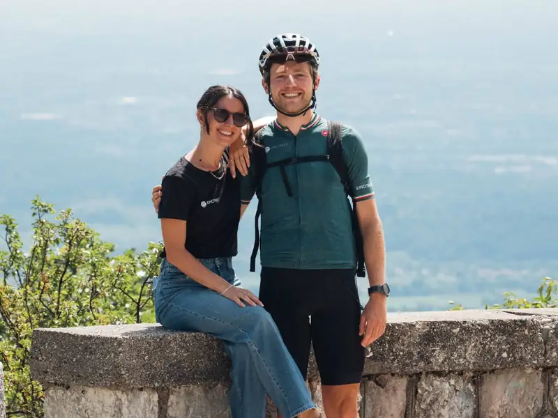 Susi and Benji at a stone wall high above the plain, Benji in his cycling kit