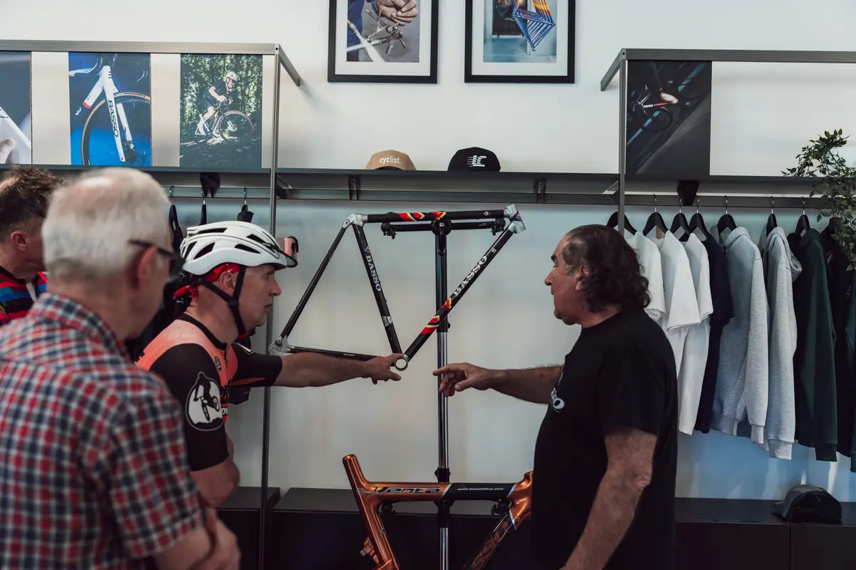 A Basso frame being shown to visiting riders inside the Basso showroom