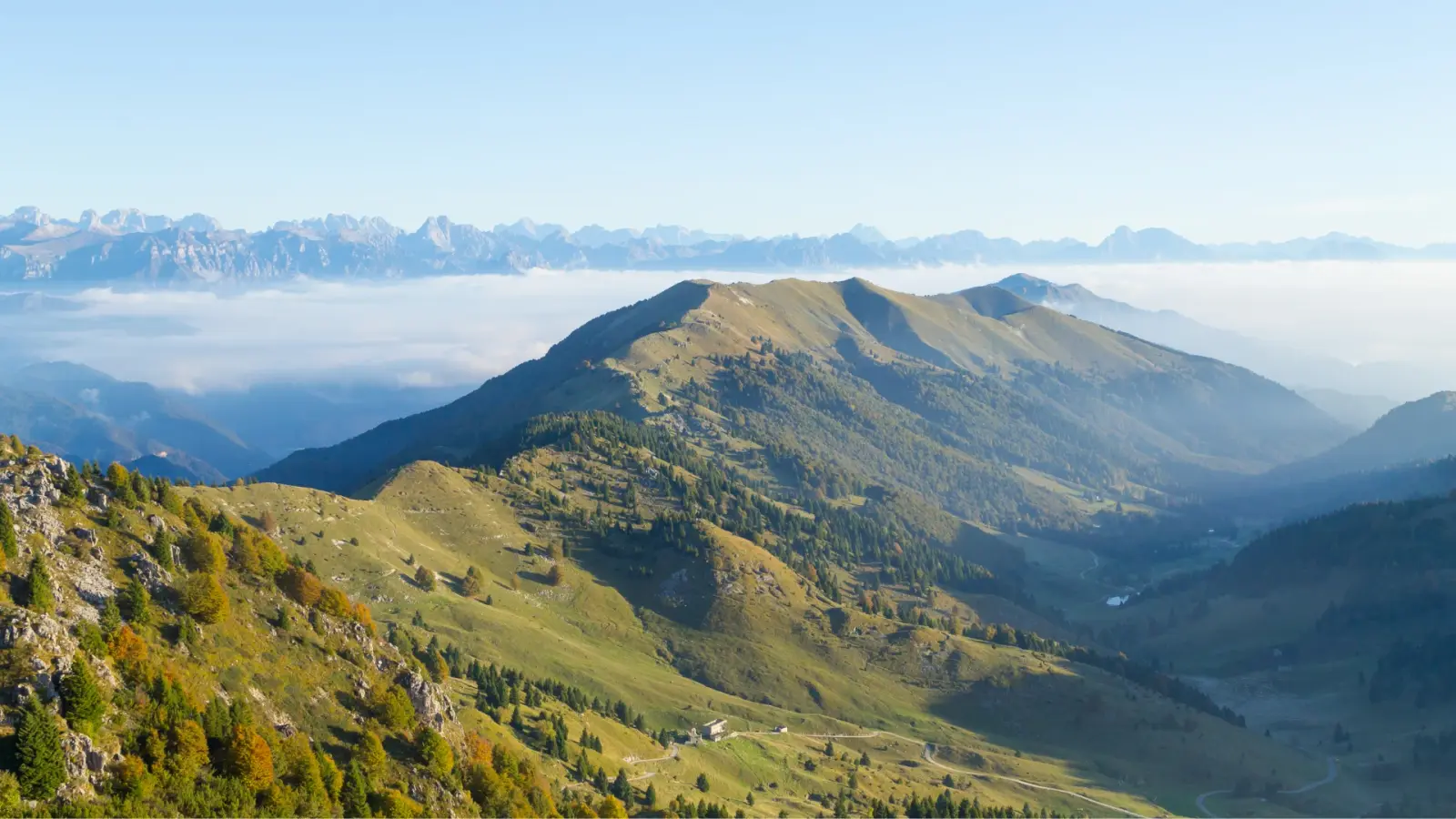Mountains above the clouds, with the Dolomites behind