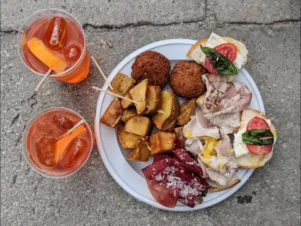 Spritz and a plate of cicchetti on a table
