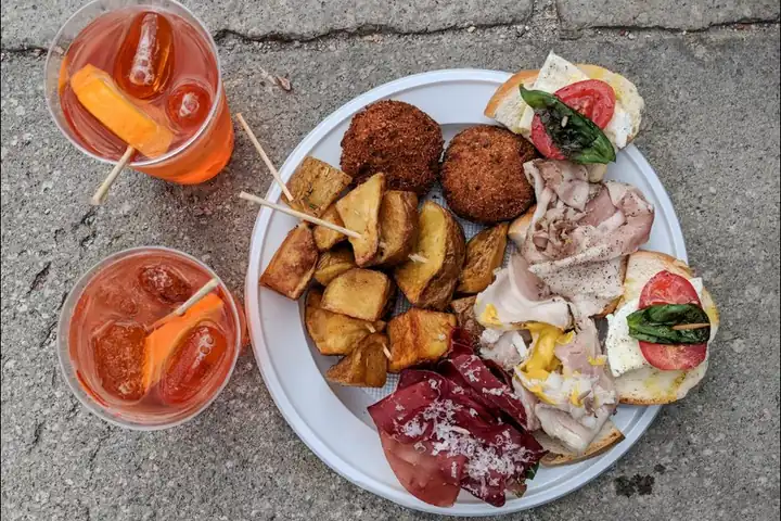 Spritz and a plate of cicchetti on a table