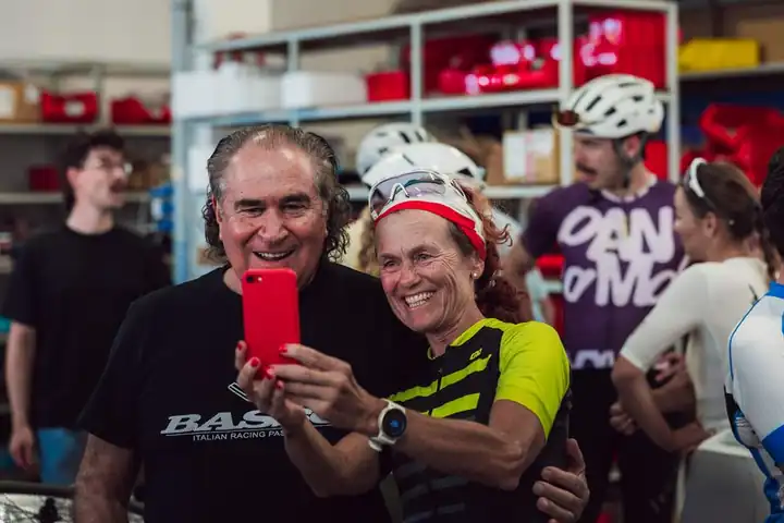 A Basso host taking a selfie with a rider inside the workshop