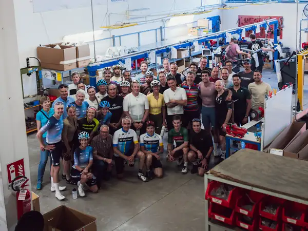 A large group of riders gathered inside the Basso factory
