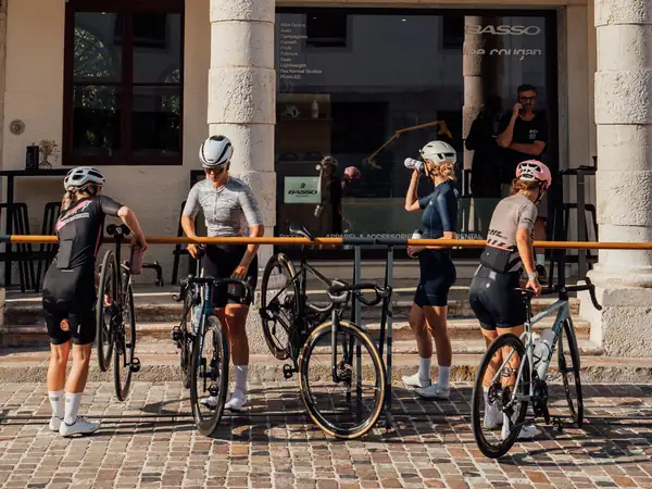 Riders having a drink under a portico in Bassano