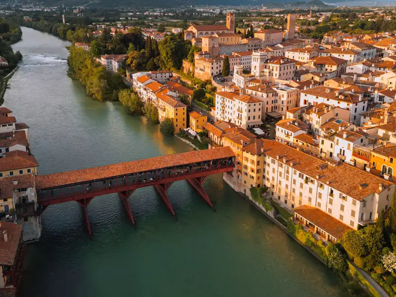 The old town of Bassano del Grappa and the covered wooden Ponte degli Alpini over the River Brenta, seen from above