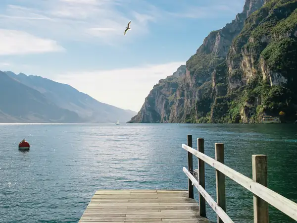 A wooden jetty on Lake Garda below steep cliffs