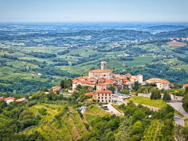 A hilltop village above vineyards and the valley