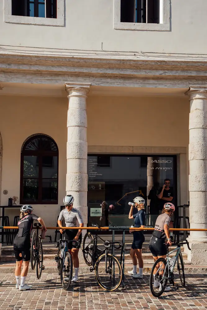Riders with their bikes outside the colonnade of Bassano Club House (BCH)