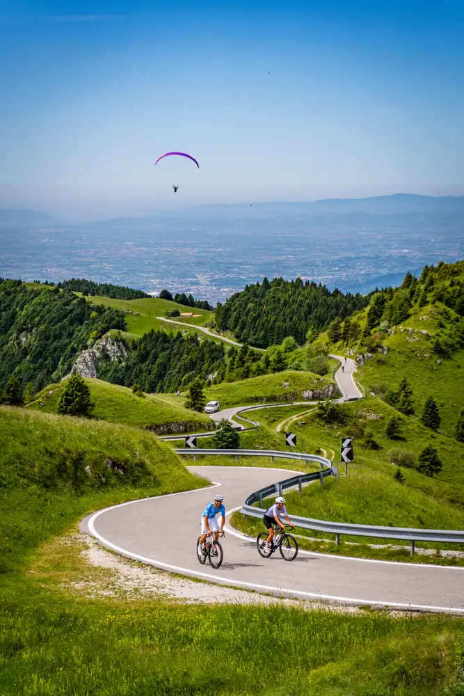Cyclist approaching the summit of Monte Grappa on one of the ten recognised roads