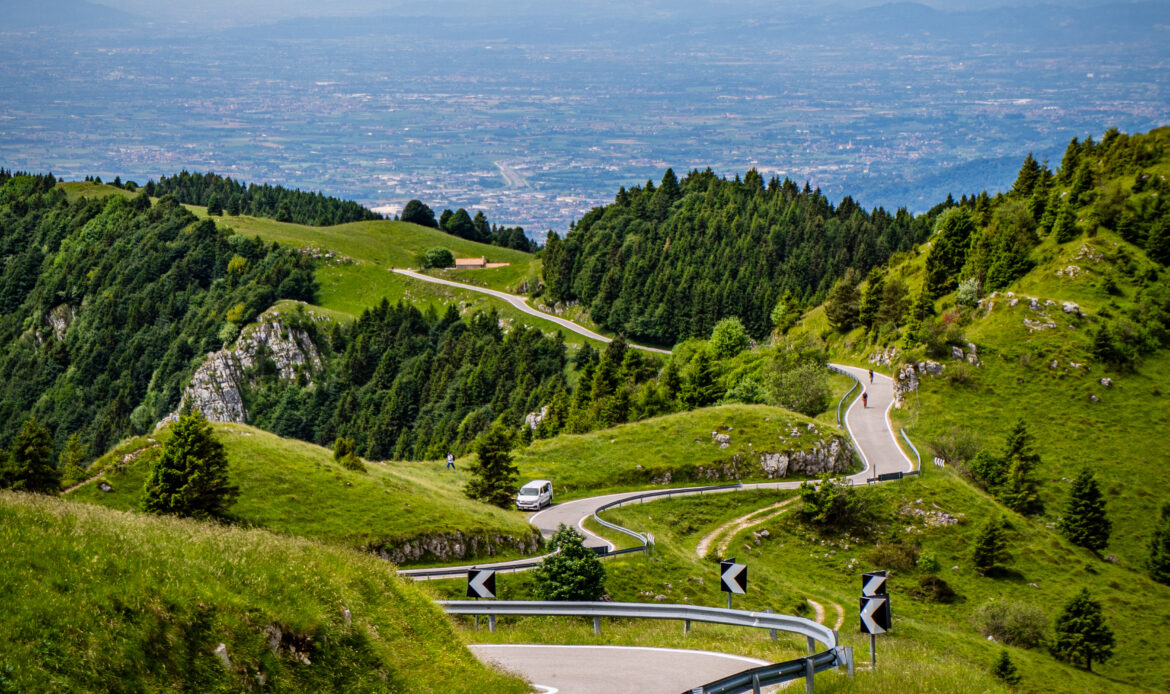 Cyclist approaching the summit of Monte Grappa on one of the ten recognised roads